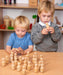 Two children playing with little wooden alphabet figures