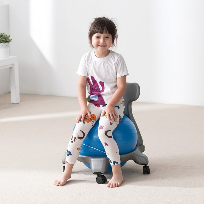 Girl sitting on a  ball chair