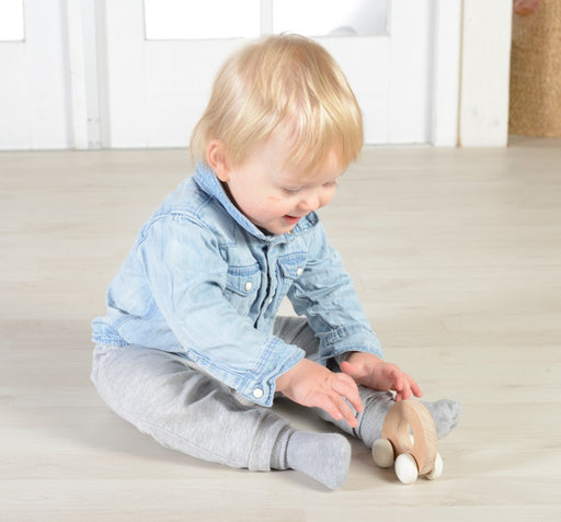 Baby playing with Wooden grabbie racer toy