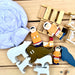 Wooden toys on a wooden surface including animals and figures.