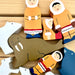 Wooden toys depicting Inuit people and animals on a wooden surface